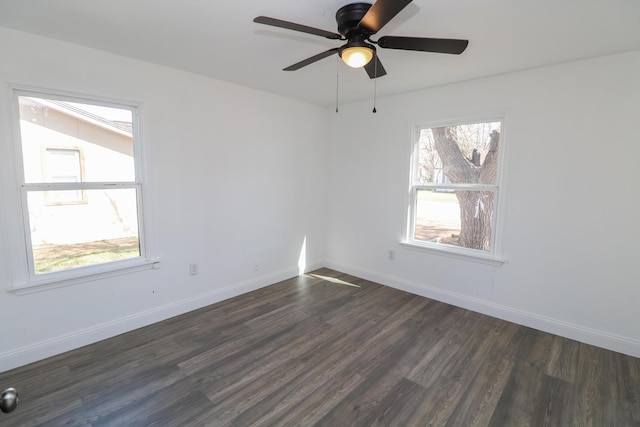 unfurnished room with dark wood-type flooring, a wealth of natural light, and ceiling fan