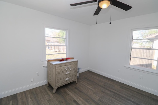 bedroom featuring ceiling fan, dark hardwood / wood-style flooring, and multiple windows