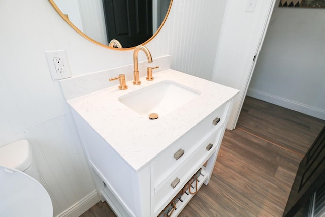 bathroom with vanity, hardwood / wood-style floors, and toilet