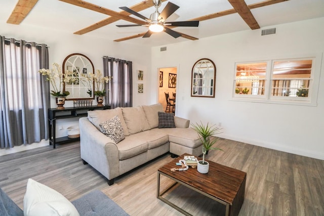 living room featuring hardwood / wood-style floors, beam ceiling, and ceiling fan