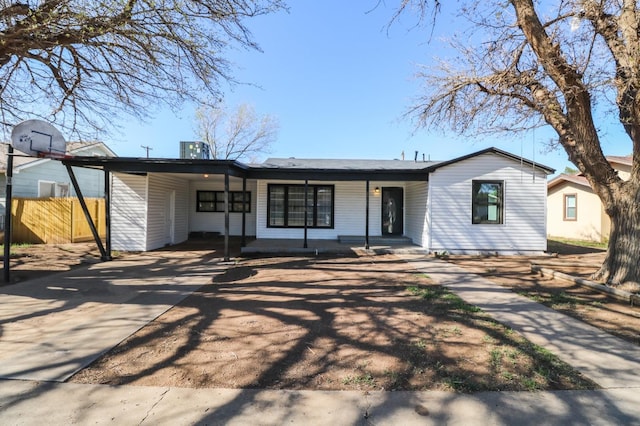 single story home with a carport, covered porch, and central air condition unit