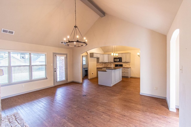 kitchen featuring a kitchen island, pendant lighting, white cabinets, and a chandelier