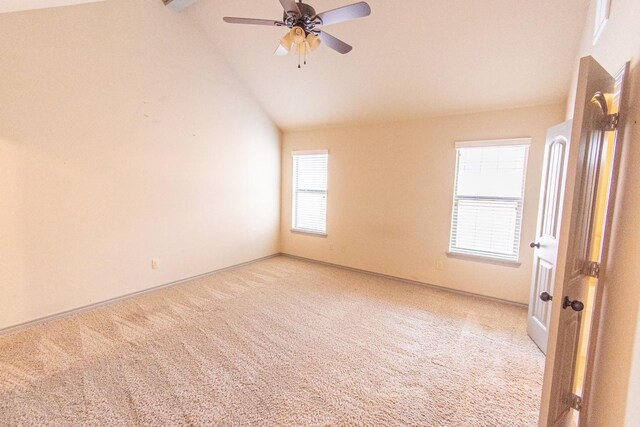 carpeted spare room with ceiling fan and high vaulted ceiling