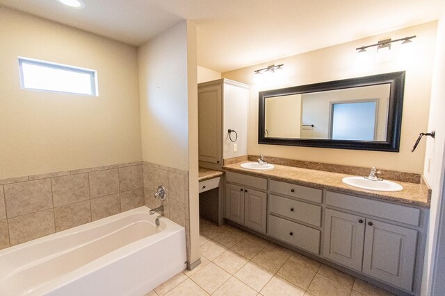 bathroom with tile patterned floors, vanity, and a washtub