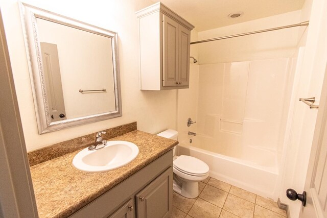 full bathroom with tile patterned floors, toilet, shower / washtub combination, and vanity