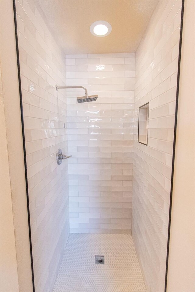 bathroom with a tile shower