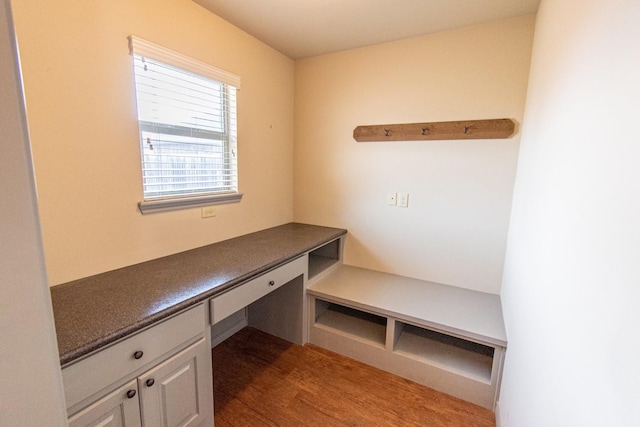 unfurnished office with wood-type flooring and built in desk