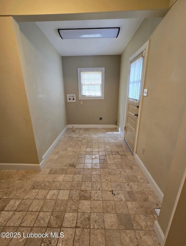 2413 25th St, Lubbock, TX 79411 - laundry area with hookup for a washing machine, baseboards, light stone finish flooring, and hookup for an electric dryer