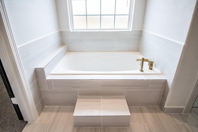 bathroom with tiled bath