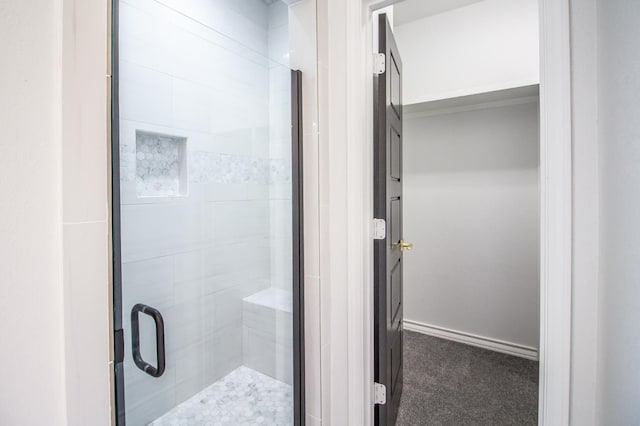 bathroom with a shower with door