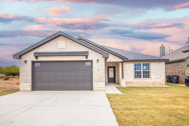 view of front of house with a garage and a lawn