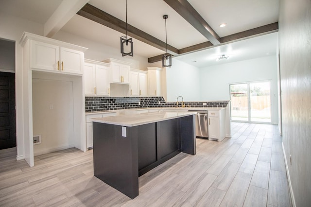 kitchen with white cabinetry, tasteful backsplash, and stainless steel dishwasher