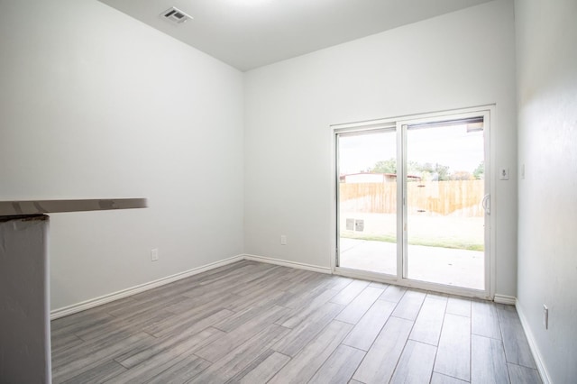 unfurnished room with light hardwood / wood-style floors