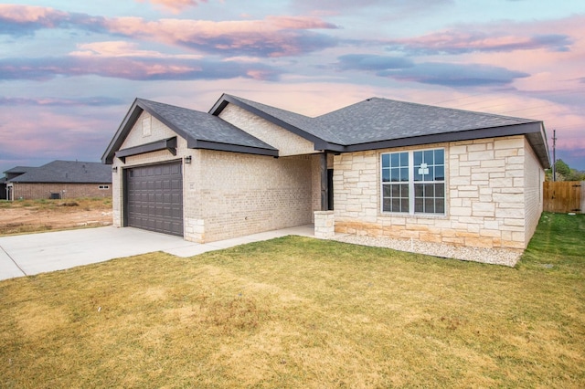 view of front facade with a garage and a lawn