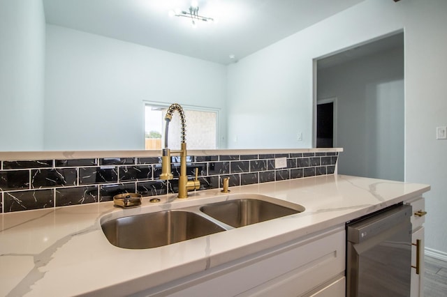 kitchen with sink, dishwasher, tasteful backsplash, wood-type flooring, and light stone countertops