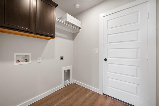 clothes washing area featuring hookup for a washing machine, electric dryer hookup, dark wood-type flooring, and cabinets