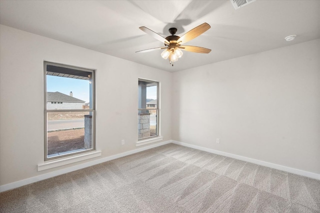 carpeted empty room featuring ceiling fan