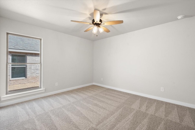 unfurnished room featuring ceiling fan and carpet floors