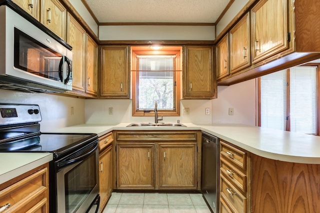 kitchen featuring kitchen peninsula, stainless steel appliances, sink, a textured ceiling, and crown molding