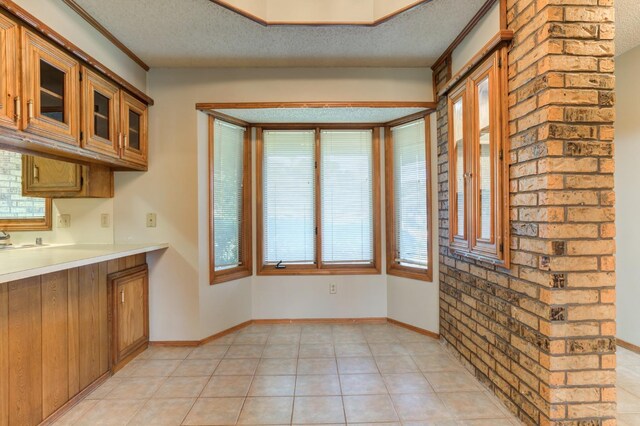 kitchen with light tile patterned floors and a textured ceiling