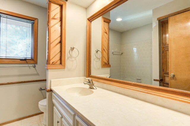 bathroom with toilet, vanity, and tile patterned flooring