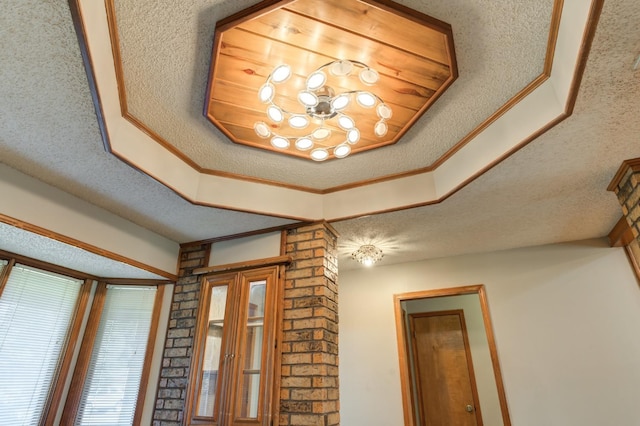 room details featuring a textured ceiling and ornamental molding