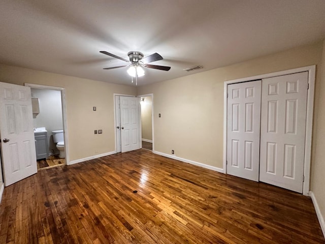 unfurnished bedroom featuring a closet, dark hardwood / wood-style floors, ceiling fan, and ensuite bathroom