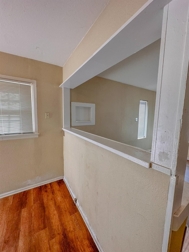 hall with hardwood / wood-style flooring