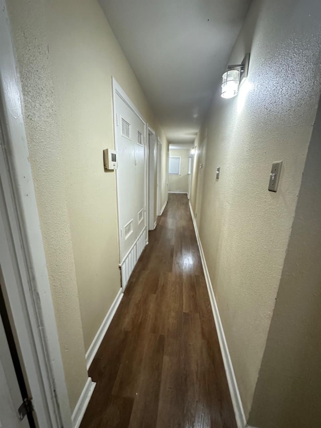 corridor featuring dark hardwood / wood-style flooring