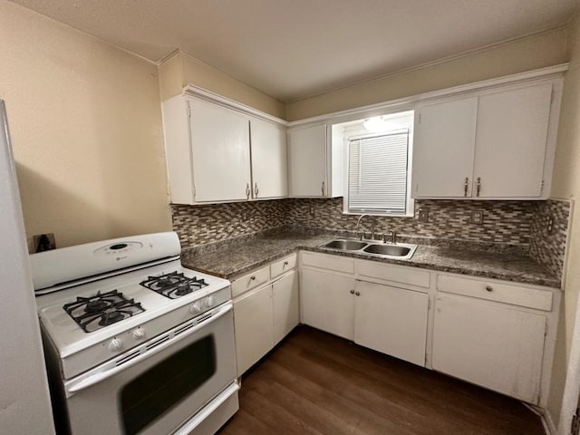 kitchen with dark hardwood / wood-style floors, tasteful backsplash, sink, white cabinets, and white gas range oven