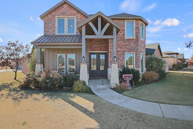 721 N 7th St, Wolfforth, TX 79382 - view of front facade with board and batten siding, a front yard, french doors, and brick siding