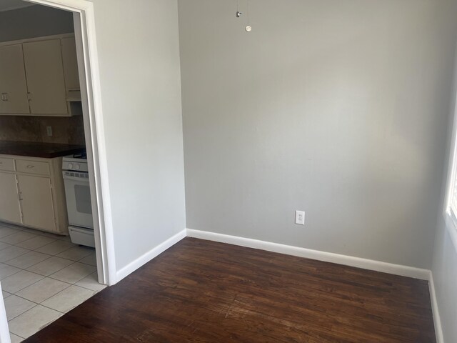 2602 45th St, Lubbock, TX 79413 - unfurnished dining area featuring light wood-style flooring and baseboards