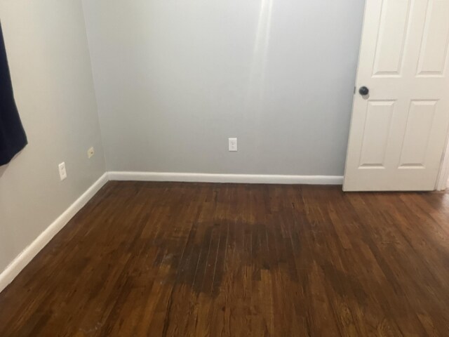 2602 45th St, Lubbock, TX 79413 - empty room with dark wood-style flooring and baseboards