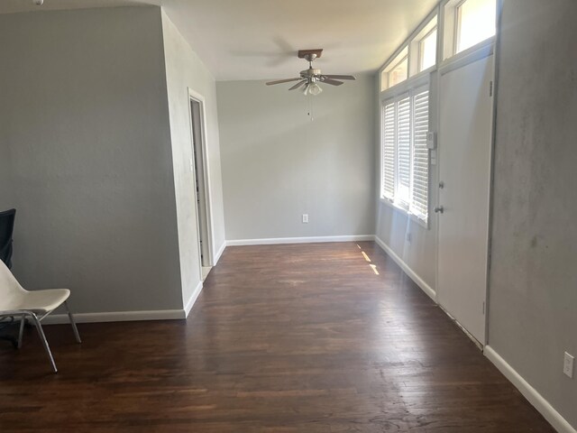 2602 45th St, Lubbock, TX 79413 - empty room with a ceiling fan, dark wood finished floors, and baseboards