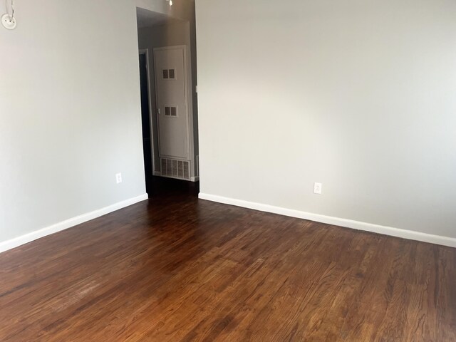 2602 45th St, Lubbock, TX 79413 - unfurnished room featuring baseboards and dark wood finished floors