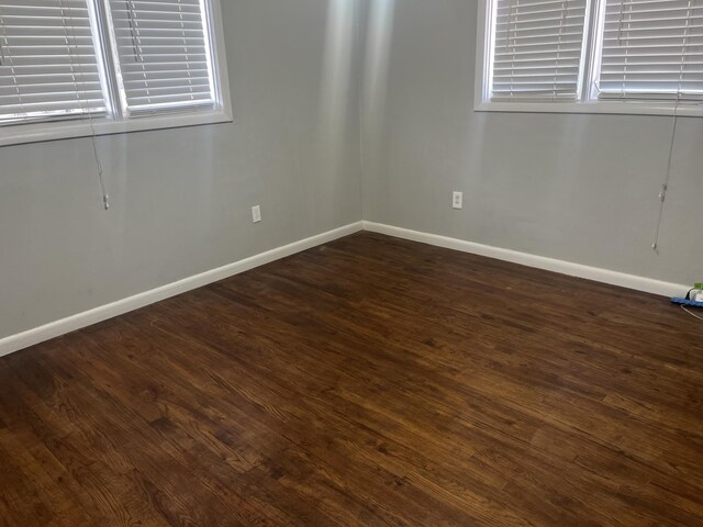 2602 45th St, Lubbock, TX 79413 - spare room featuring baseboards and dark wood-style flooring