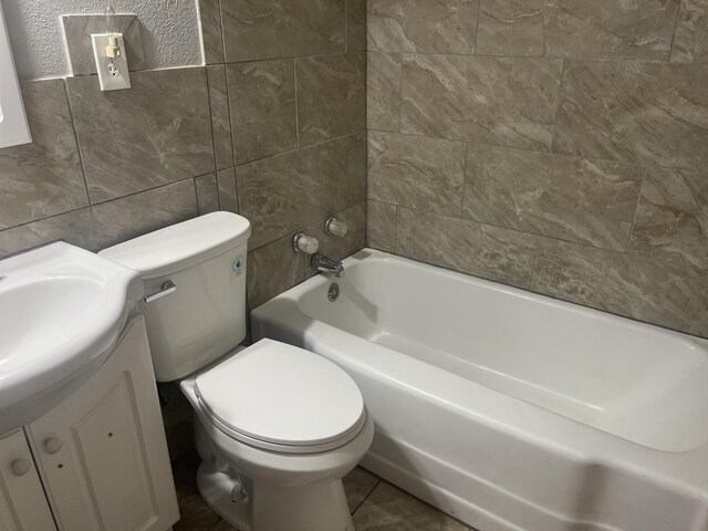 2602 45th St, Lubbock, TX 79413 - bathroom featuring tile walls, vanity, and toilet