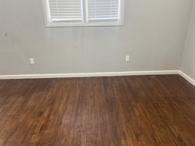 2602 45th St, Lubbock, TX 79413 - spare room featuring baseboards and dark wood-style floors