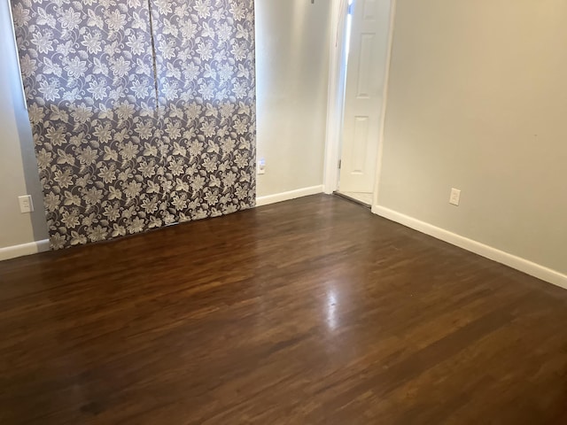 2602 45th St, Lubbock, TX 79413 - spare room featuring baseboards and dark wood-type flooring