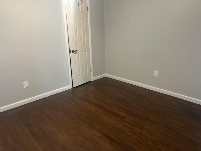 2602 45th St, Lubbock, TX 79413 - unfurnished room featuring baseboards and dark wood-type flooring
