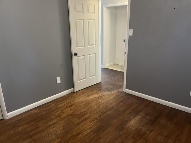 2602 45th St, Lubbock, TX 79413 - unfurnished room with baseboards and dark wood-style floors