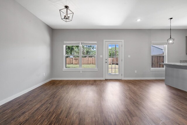 unfurnished living room with dark hardwood / wood-style flooring