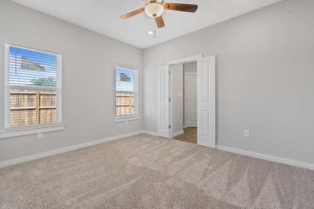 unfurnished bedroom with ceiling fan and carpet flooring