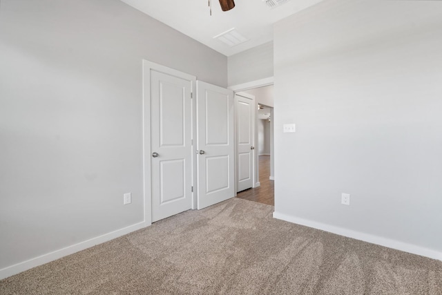 unfurnished bedroom with ceiling fan and carpet