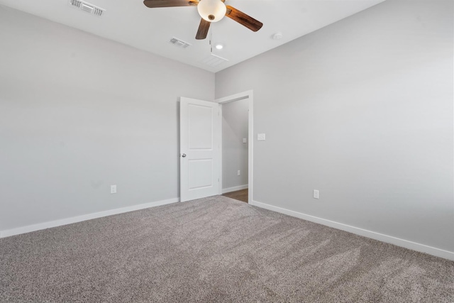 carpeted spare room with ceiling fan