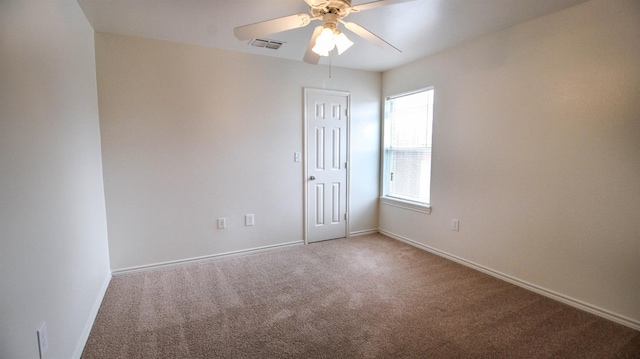 carpeted empty room featuring ceiling fan