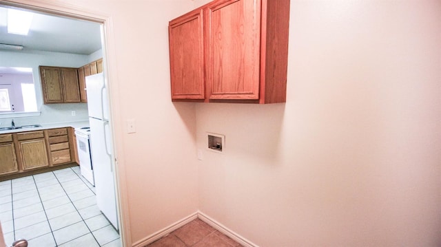 laundry room featuring light tile patterned flooring, sink, and washer hookup