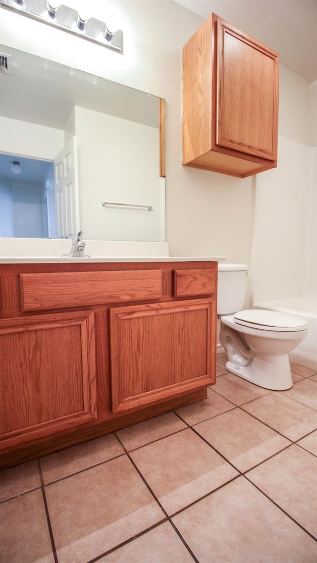 bathroom with tile patterned flooring, vanity, and toilet