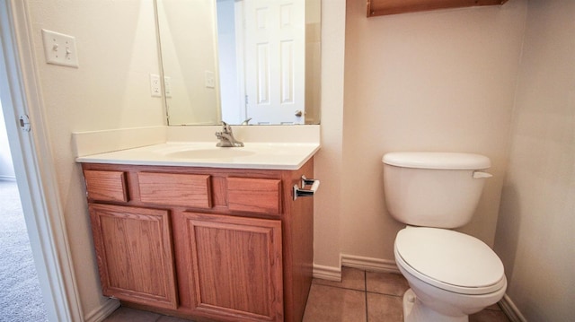 bathroom with vanity, toilet, and tile patterned flooring