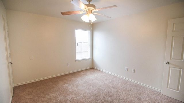 spare room with light carpet and ceiling fan